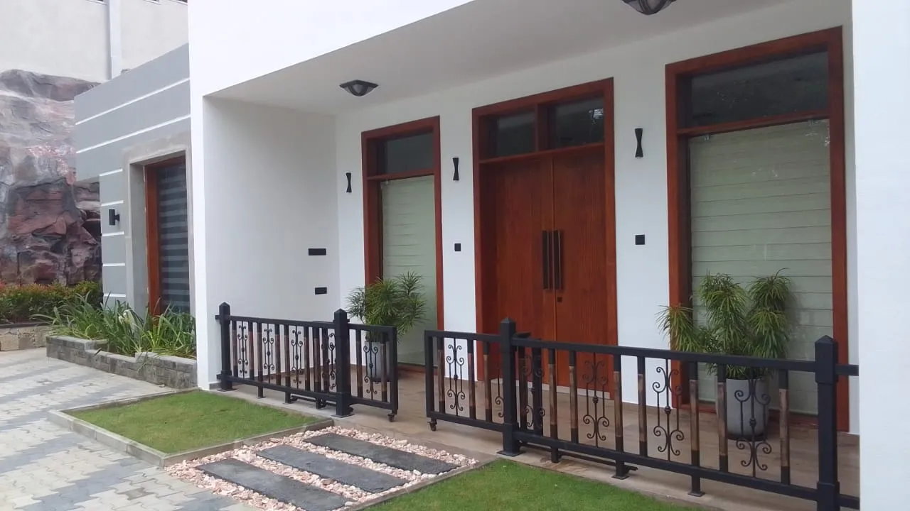 Modern house front facade with wooden door and glass windows built by Unicon